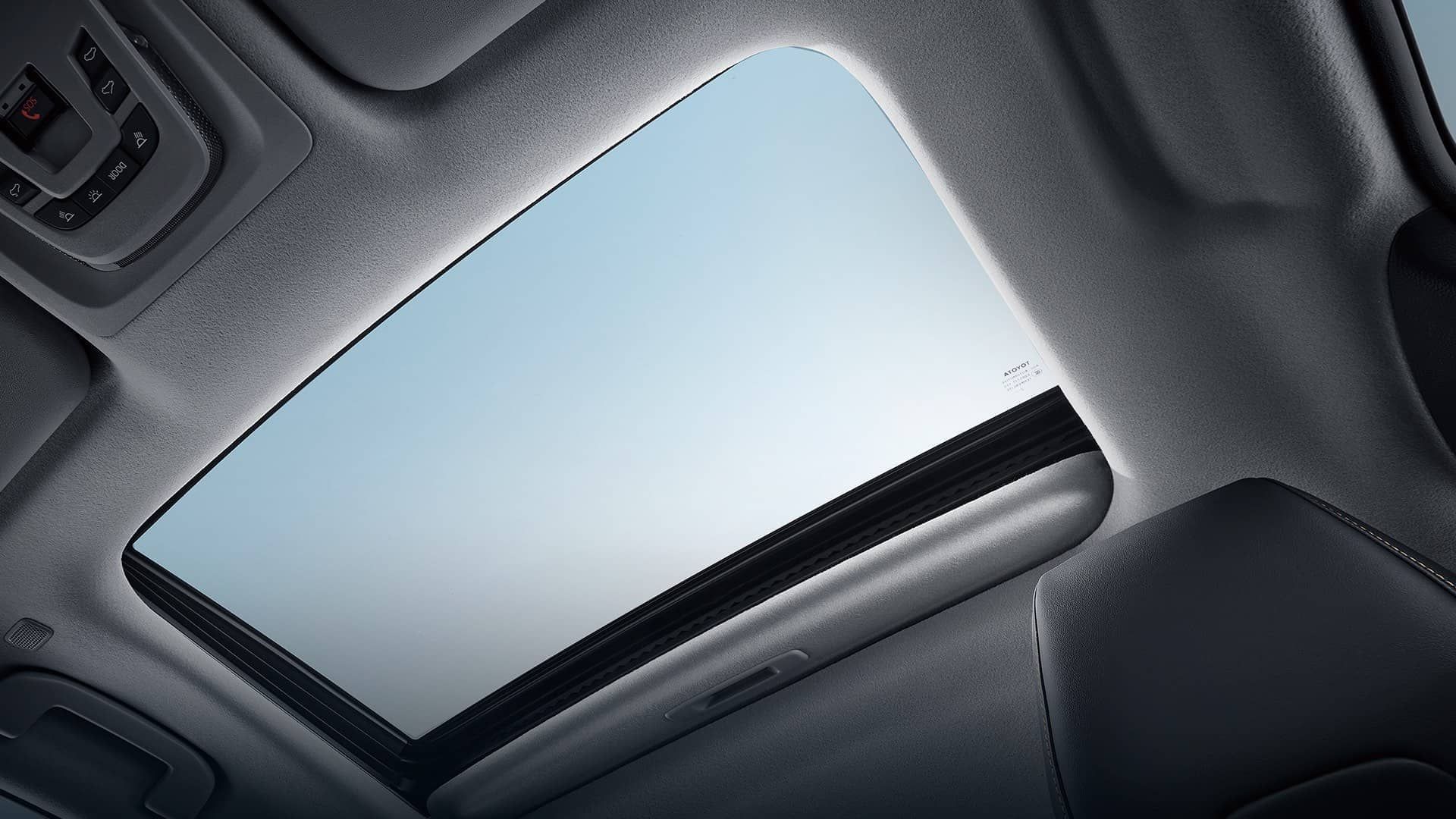 Kettle spout pouring boiling water into coffee grounds in pour-over mug.